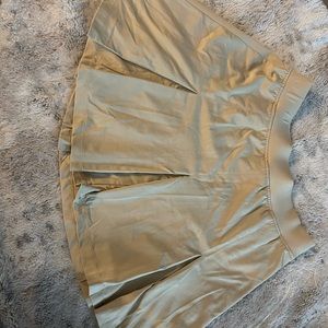 NWOT pleated tan mini skirt.